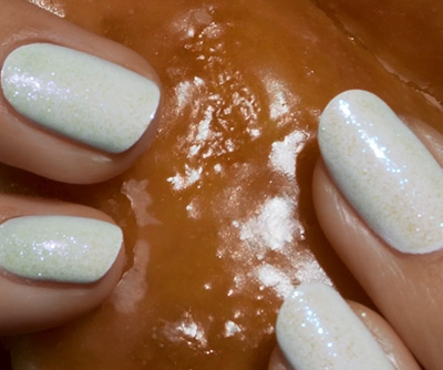 Image of white glazed nails on a glazed donut